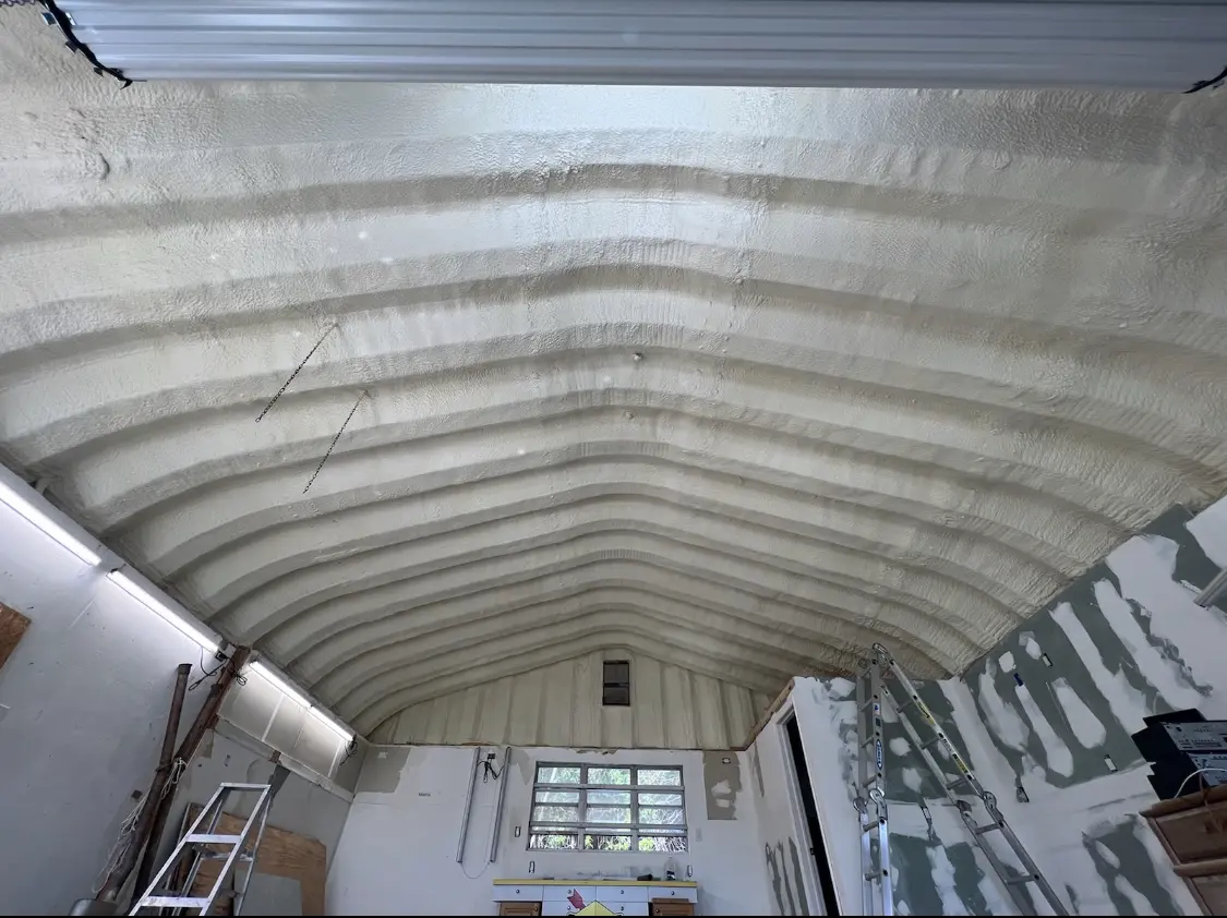 Spray polyurethane foam applied to the underside of a metal roof deck in Spring